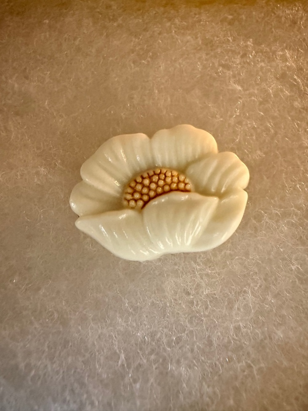 A finely carved shell or bone magnolia flower brooch